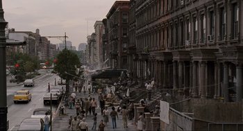 Movie still from “American Gangster” (2007), directed by Ridley Scott – A group of people walking down a sidewalk; Extreme Wide shot, High angle