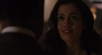 Movie still from “American Gangster” (2007), directed by Ridley Scott – A woman's face in a dark room; Close Up shot, Over the shoulder angle