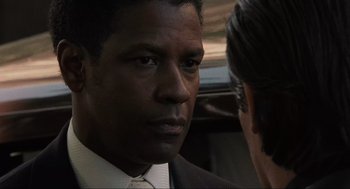 Movie still from “American Gangster” (2007), directed by Ridley Scott – A man in a suit and a tie; Close Up shot, Over the shoulder angle