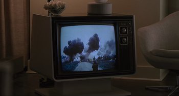 Movie still from “American Gangster” (2007), directed by Ridley Scott – An old television set with smoke coming out of it's screen; Extreme Close Up shot, Over the shoulder angle