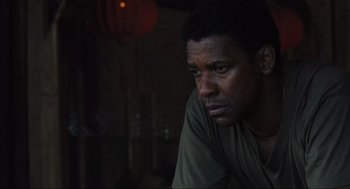 Movie still from “American Gangster” (2007), directed by Ridley Scott – A person sitting in front of a window; Close Up shot, Over the shoulder angle