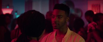Movie still from “The Hate U Give” (2018), directed by George Tillman Jr. – A man with a beard and a mustache is in the dark; Close Up shot, Over the shoulder angle