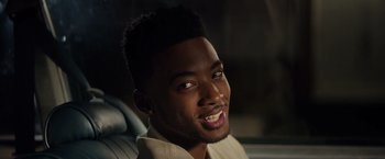 Movie still from “The Hate U Give” (2018), directed by George Tillman Jr. – A person with a smile on their face; Close Up shot, Over the shoulder angle