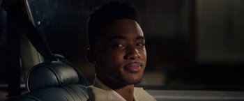 Movie still from “The Hate U Give” (2018), directed by George Tillman Jr. – A person sitting in a car; Close Up shot, Over the shoulder angle
