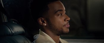 Movie still from “The Hate U Give” (2018), directed by George Tillman Jr. – A person wearing a white shirt; Close Up shot, Over the shoulder angle