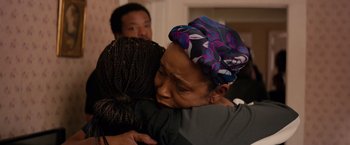 Movie still from “The Hate U Give” (2018), directed by George Tillman Jr. – Two women are hugging each other in a room; Close Up shot, Over the shoulder angle