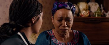 Movie still from “The Hate U Give” (2018), directed by George Tillman Jr. – An older woman is crying in front of a younger woman; Close Up shot, Over the shoulder angle