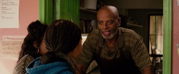 Movie still from “The Hate U Give” (2018), directed by George Tillman Jr. – An older man and a young woman in a kitchen talking; Close Up shot, Over the shoulder angle