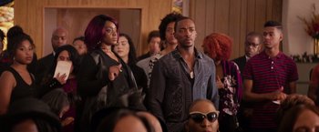 Movie still from “The Hate U Give” (2018), directed by George Tillman Jr. – A group of people standing in front of a wall; Medium shot, Over the shoulder angle