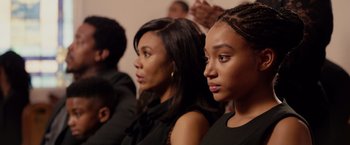 Movie still from “The Hate U Give” (2018), directed by George Tillman Jr. – A group of people that are sitting in a room; Close Up shot, Over the shoulder angle