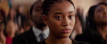 Movie still from “The Hate U Give” (2018), directed by George Tillman Jr. – A woman with a serious look on her face; Close Up shot, Over the shoulder angle
