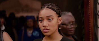 Movie still from “The Hate U Give” (2018), directed by George Tillman Jr. – A person wearing a black shirt; Close Up shot, Over the shoulder angle