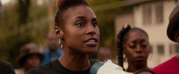 Movie still from “The Hate U Give” (2018), directed by George Tillman Jr. – A person wearing a black shirt; Close Up shot, Over the shoulder angle