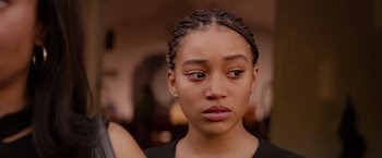 Movie still from “The Hate U Give” (2018), directed by George Tillman Jr. – A person wearing a black shirt; Close Up shot, Over the shoulder angle