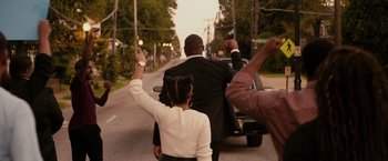 Movie still from “The Hate U Give” (2018), directed by George Tillman Jr. – A man and a woman riding on the back of a motorcycle; Medium shot, Over the shoulder angle