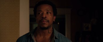 Movie still from “The Hate U Give” (2018), directed by George Tillman Jr. – A person wearing a jean jacket; Close Up shot, Over the shoulder angle