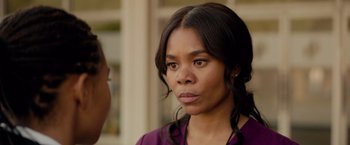 Movie still from “The Hate U Give” (2018), directed by George Tillman Jr. – A person wearing a purple shirt; Close Up shot, Over the shoulder angle