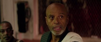 Movie still from “The Hate U Give” (2018), directed by George Tillman Jr. – An older bald man with a beard and mustache; Close Up shot, Low angle