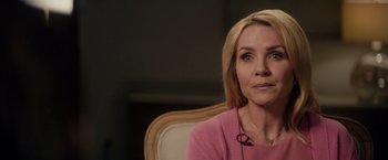 Movie still from “The Hate U Give” (2018), directed by George Tillman Jr. – A woman sitting in a chair wearing a pink shirt; Close Up shot, Over the shoulder angle