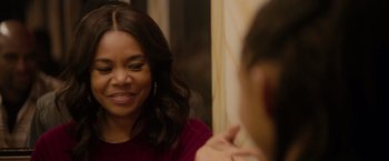 Movie still from “The Hate U Give” (2018), directed by George Tillman Jr. – A woman is looking at her reflection in the mirror; Close Up shot, Over the shoulder angle