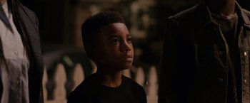Movie still from “The Hate U Give” (2018), directed by George Tillman Jr. – A young boy is looking up into the sky; Close Up shot, Over the shoulder angle