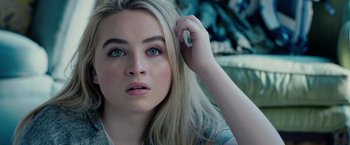 Movie still from “The Hate U Give” (2018), directed by George Tillman Jr. – A person holding her hand up to her head; Close Up shot, High angle