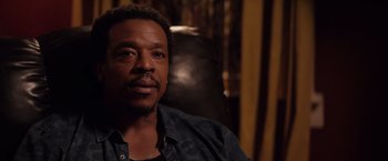 Movie still from “The Hate U Give” (2018), directed by George Tillman Jr. – A person sitting in a chair; Close Up shot, Over the shoulder angle