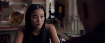 Movie still from “The Hate U Give” (2018), directed by George Tillman Jr. – A young woman sitting in front of a fire place; Close Up shot, Over the shoulder angle