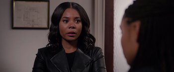 Movie still from “The Hate U Give” (2018), directed by George Tillman Jr. – A woman wearing a black leather jacket looking into a mirror; Close Up shot, Over the shoulder angle