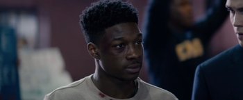 Movie still from “The Hate U Give” (2018), directed by George Tillman Jr. – A person wearing a shirt; Close Up shot, Over the shoulder angle