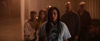 Movie still from “The Hate U Give” (2018), directed by George Tillman Jr. – A group of people standing in a room; Medium shot, Over the shoulder angle