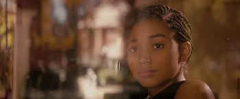 Movie still from “The Hate U Give” (2018), directed by George Tillman Jr. – A young girl looking out of a window; Close Up shot, Over the shoulder angle