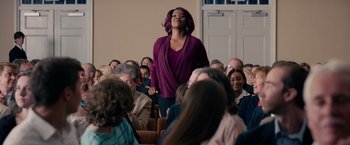 Movie still from “The Hate U Give” (2018), directed by George Tillman Jr. – A woman standing in front of a crowd of onlookers; Medium shot, Low angle