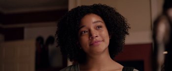 Movie still from “The Hate U Give” (2018), directed by George Tillman Jr. – A person with curly black hair; Close Up shot, Low angle