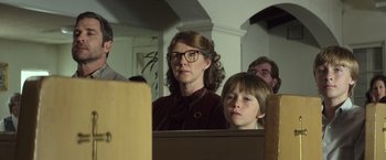 Movie still from “American Sniper” (2014), directed by Clint Eastwood – A woman and a boy are looking into a mirror; Close Up shot, Low angle