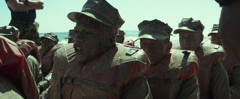 Movie still from “American Sniper” (2014), directed by Clint Eastwood – A group of men standing next to each other; Close Up shot, High angle