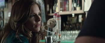 Movie still from “American Sniper” (2014), directed by Clint Eastwood – A woman sitting at a bar looking into the distance; Close Up shot, Over the shoulder angle