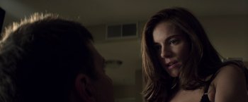 Movie still from “American Sniper” (2014), directed by Clint Eastwood – A man and a woman looking at one another in the dark; Close Up shot, Over the shoulder angle