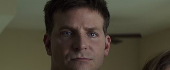 Movie still from “American Sniper” (2014), directed by Clint Eastwood – A man's face with blue eyes; Close Up shot, Over the shoulder angle