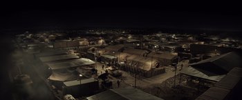 Movie still from “American Sniper” (2014), directed by Clint Eastwood – An aerial view of tents in the dark at night; Extreme Wide shot, High angle
