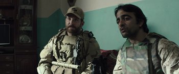 Movie still from “American Sniper” (2014), directed by Clint Eastwood – Two men in camouflage sitting on a couch; Close Up shot, Over the shoulder angle