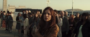 Movie still from “American Sniper” (2014), directed by Clint Eastwood – A group of people standing in a crowd; Medium shot, Over the shoulder angle