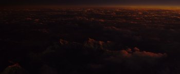 Movie still from “American Sniper” (2014), directed by Clint Eastwood – A view of the sky from an airplane at night; Extreme Wide shot, Overhead angle