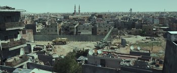 Movie still from “American Sniper” (2014), directed by Clint Eastwood – An aerial view of an urban area with buildings; Extreme Wide shot, High angle