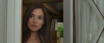 Movie still from “American Sniper” (2014), directed by Clint Eastwood – A person with long brown hair; Close Up shot, Over the shoulder angle