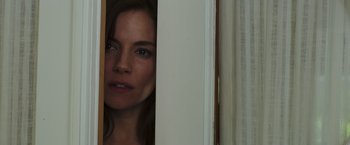 Movie still from “American Sniper” (2014), directed by Clint Eastwood – A person looking out a window; Close Up shot, Over the shoulder angle