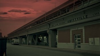 Movie still from “Amityville Uprising” (2022), directed by Thomas J. Churchill – A train station with a red sky in the background; Extreme Wide shot, Low angle