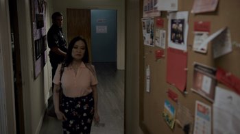 Movie still from “Amityville Uprising” (2022), directed by Thomas J. Churchill – A woman standing in a hallway next to a man; Medium shot, Over the shoulder angle
