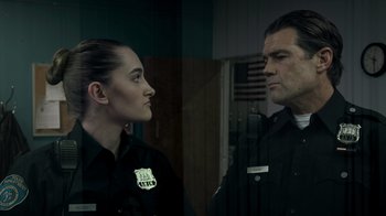 Movie still from “Amityville Uprising” (2022), directed by Thomas J. Churchill – Two police officers are standing next to each other; Close Up shot, Over the shoulder angle