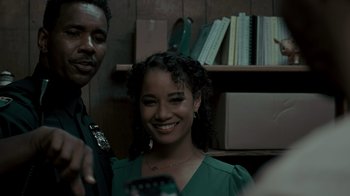 Movie still from “Amityville Uprising” (2022), directed by Thomas J. Churchill – A man and a woman smile for a picture; Close Up shot, Over the shoulder angle
